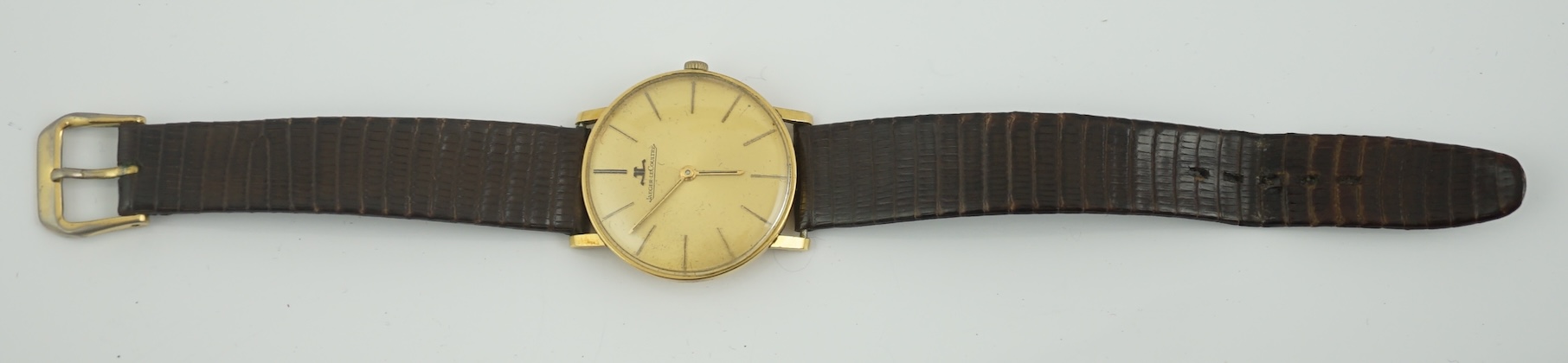 A gentleman's 18ct gold Jaeger LeCoultre manual wind dress wrist watch, on an associated strap